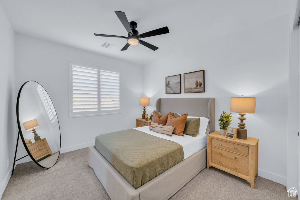 Carpeted bedroom with ceiling fan