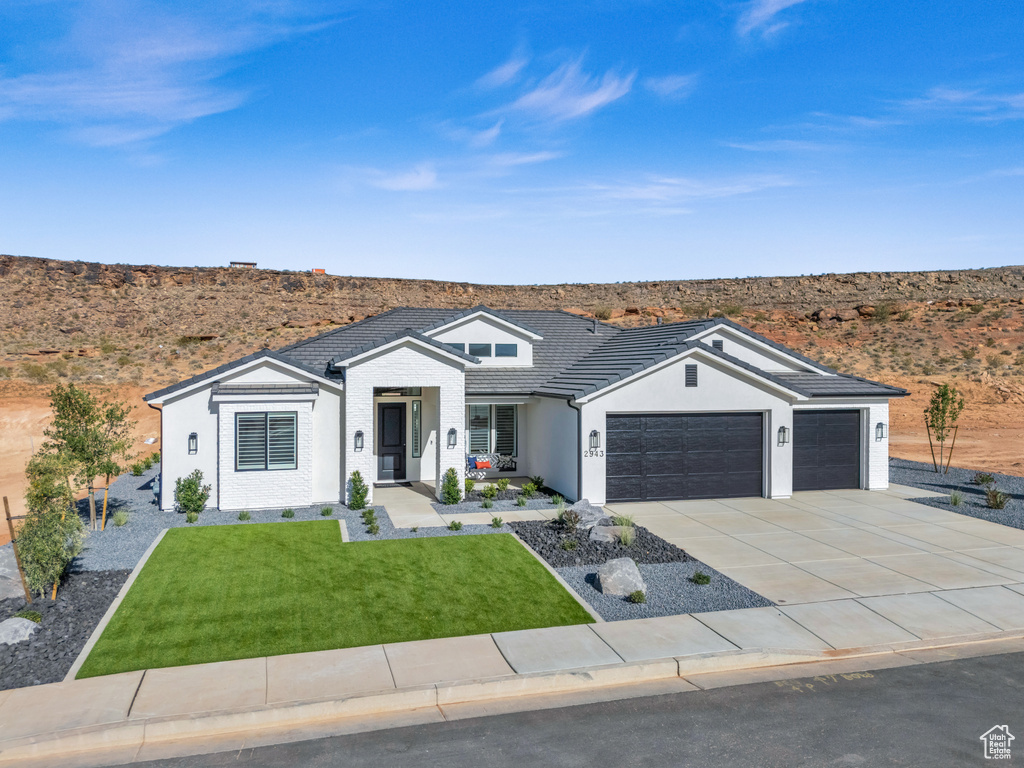 Single story home featuring a front lawn and a garage