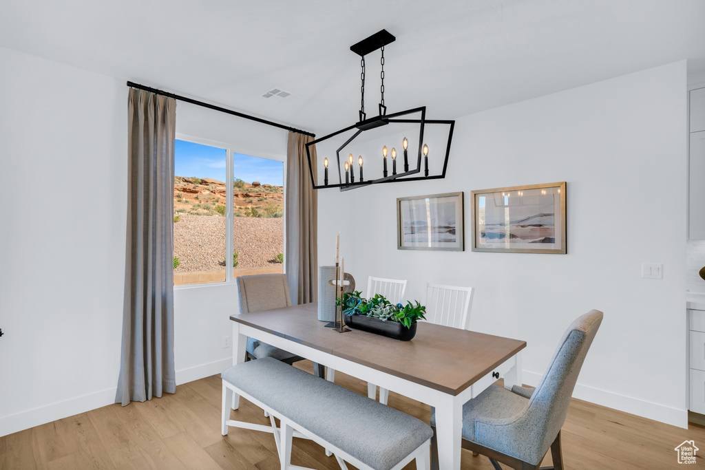 Dining space featuring an inviting chandelier and light hardwood / wood-style flooring