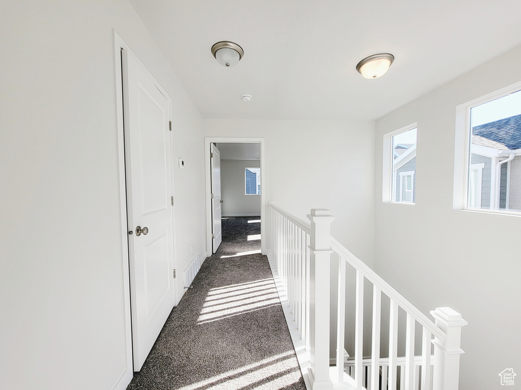 Hallway with dark carpet