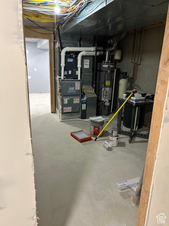 Utility room with water heater and heating unit