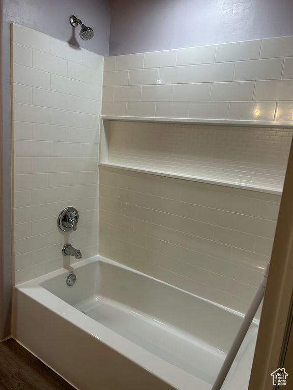 Bathroom featuring  shower combination and hardwood / wood-style floors