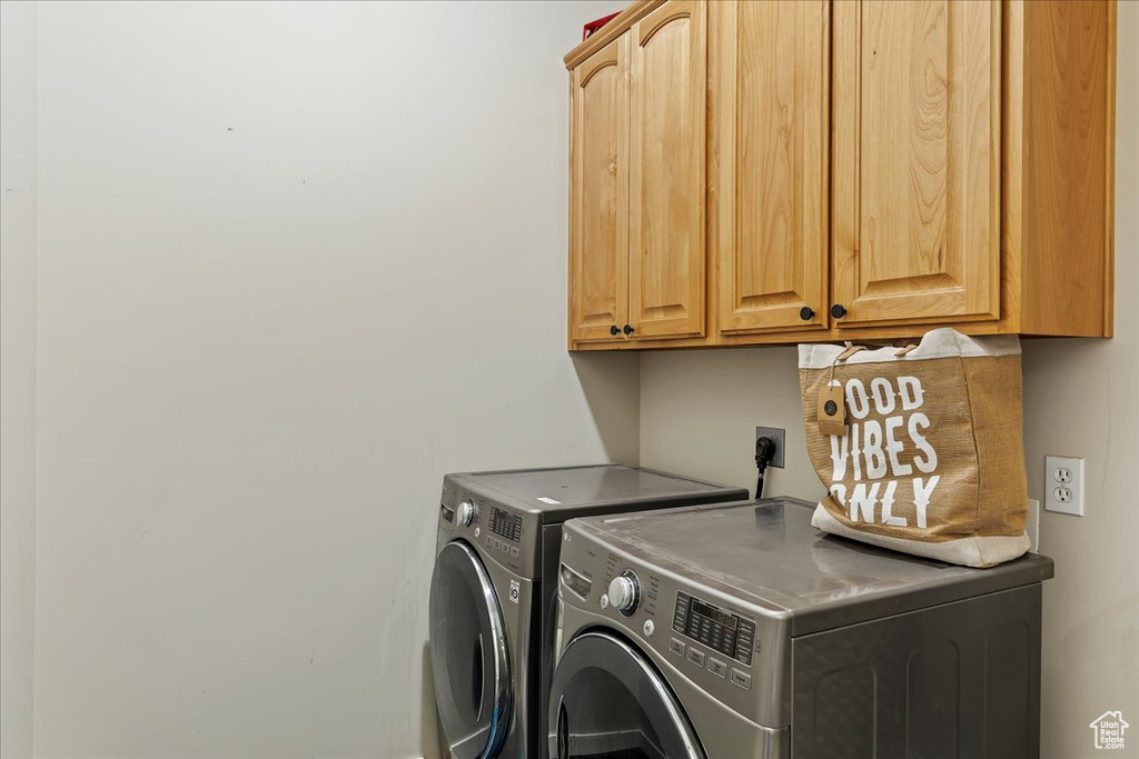 Laundry room with cabinets and separate washer and dryer