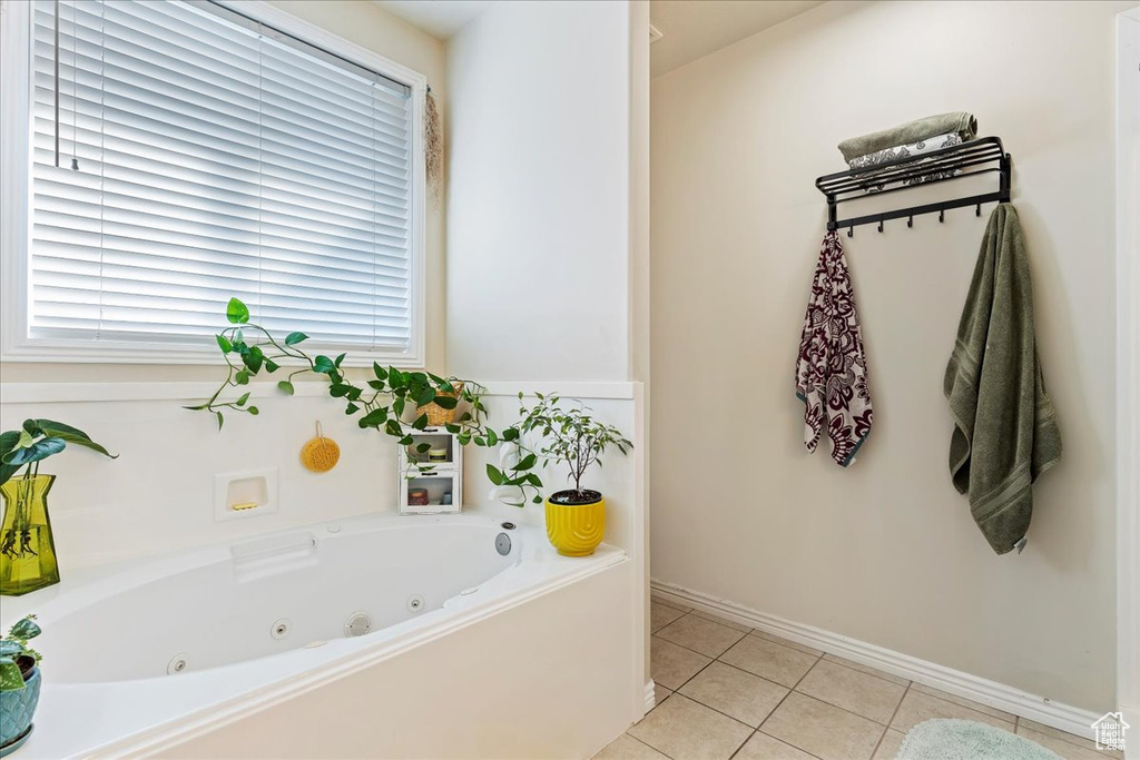 Bathroom with a tub to relax in and tile patterned floors