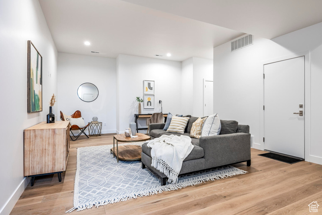 Living room with light hardwood / wood-style flooring