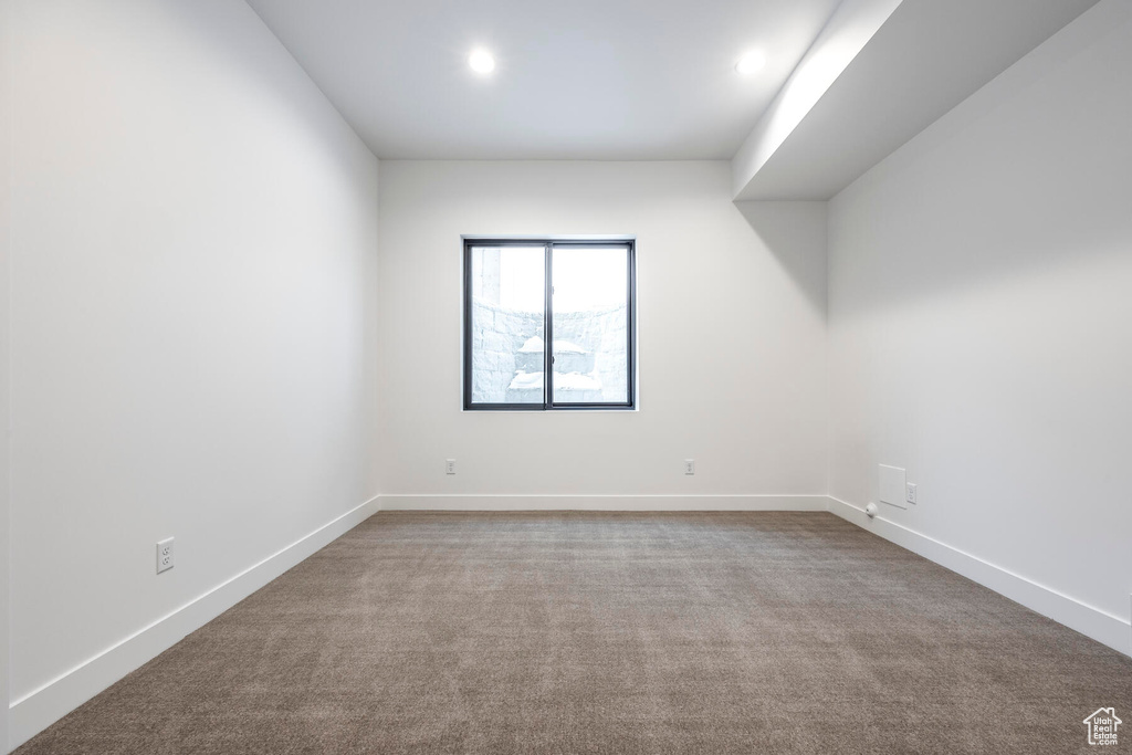 Empty room featuring light carpet