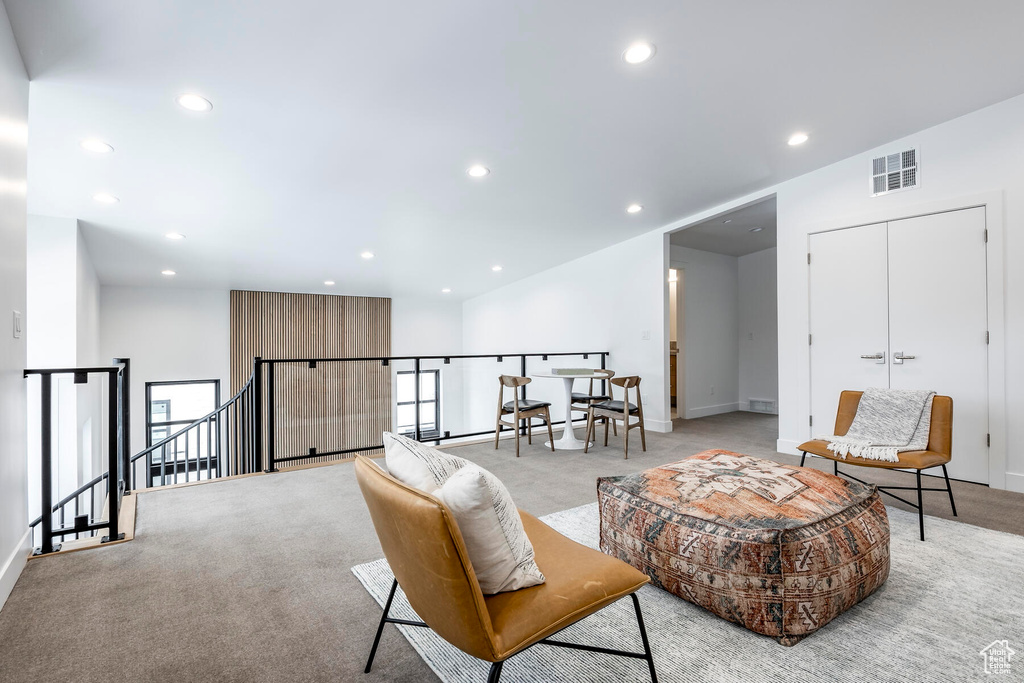 Sitting room featuring light carpet