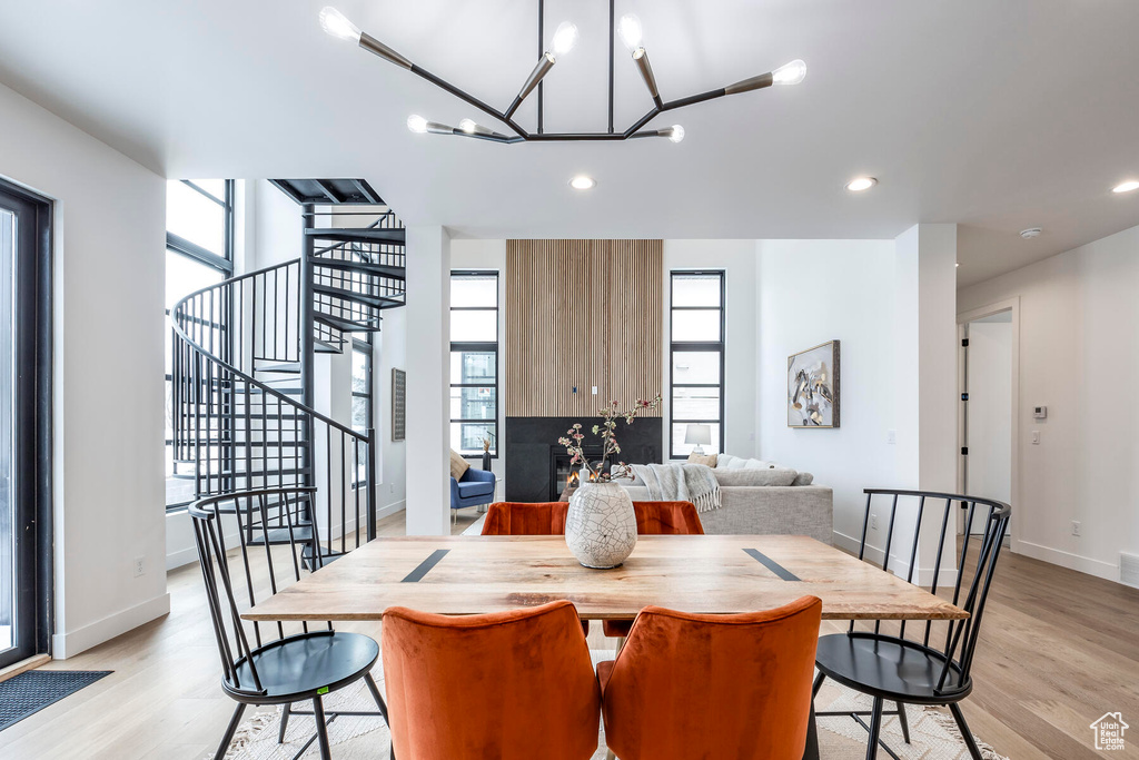 Dining space featuring light wood-type flooring and a notable chandelier