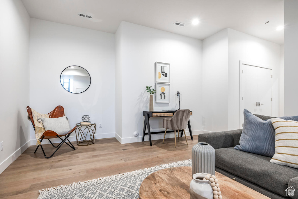 Living room with light hardwood / wood-style floors