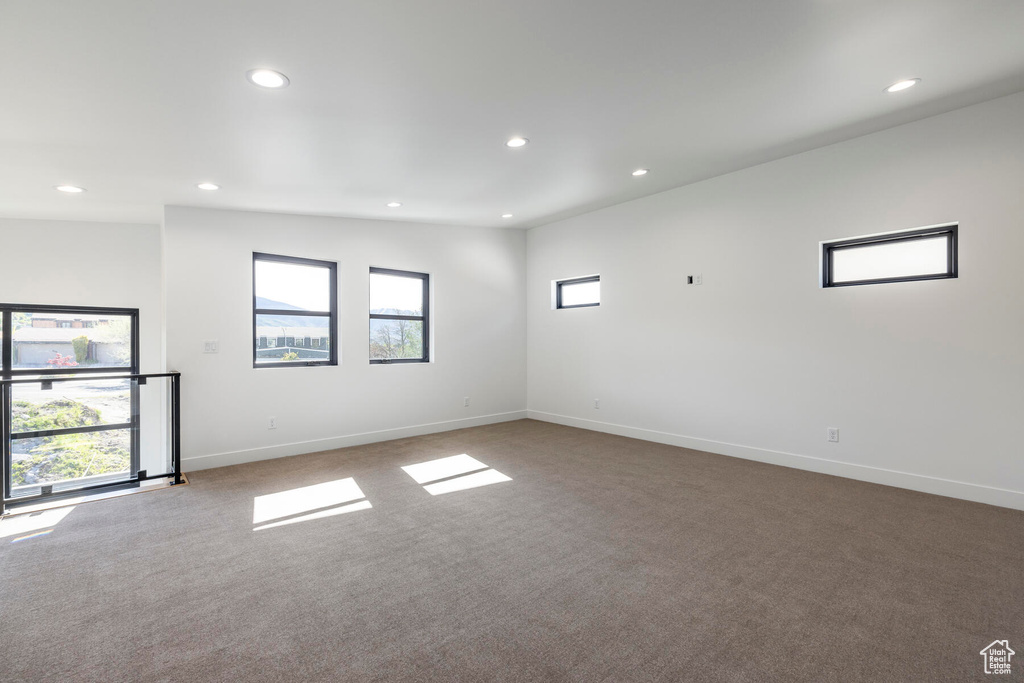 Unfurnished room with lofted ceiling and carpet floors