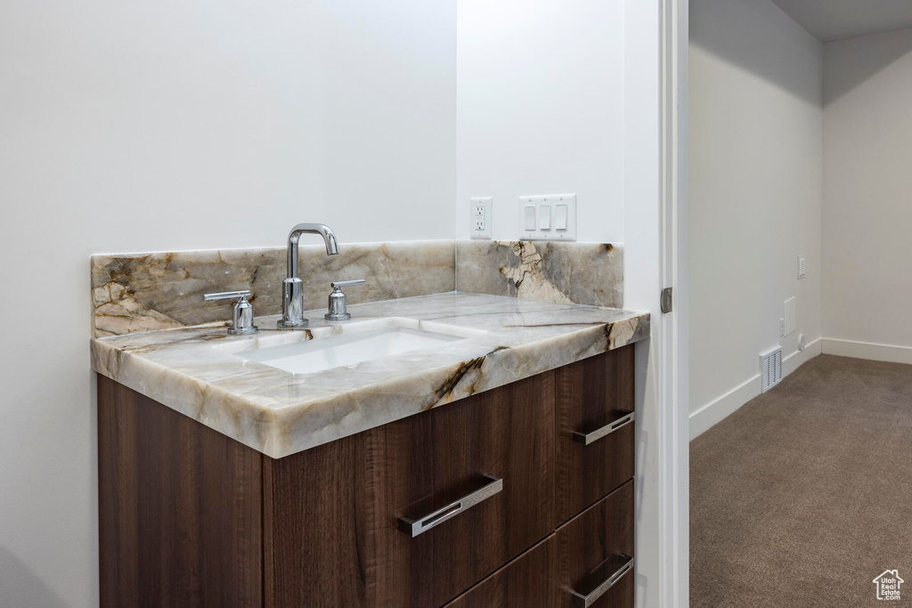 Bathroom with vanity and tasteful backsplash