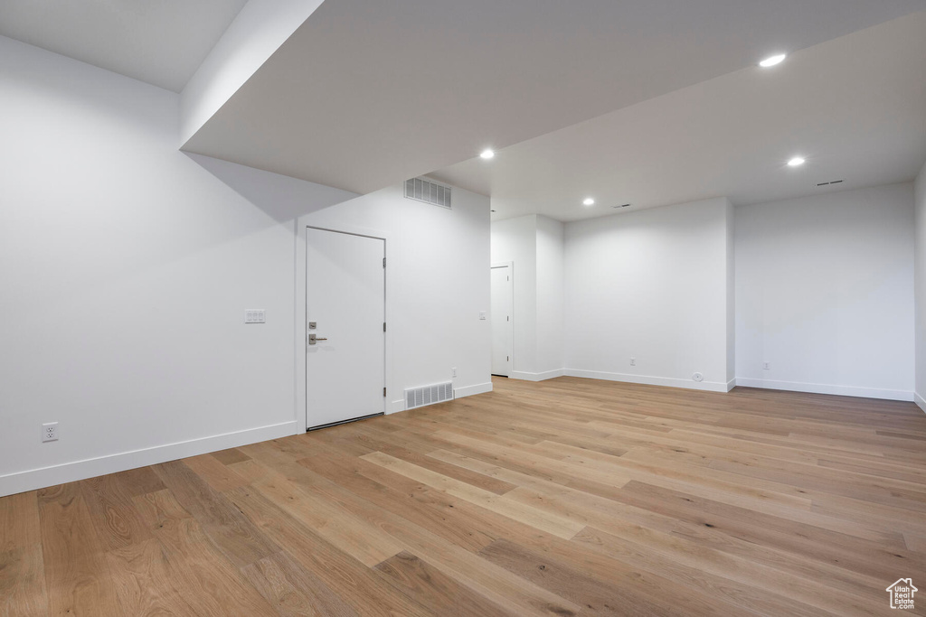 Basement featuring light wood-type flooring