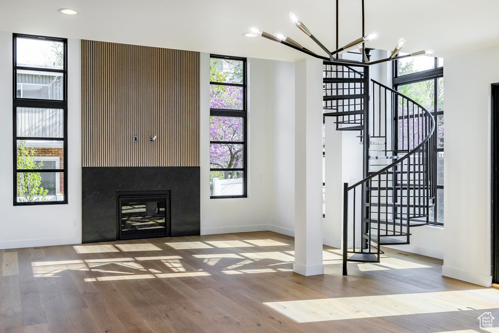 Foyer with plenty of natural light, light hardwood / wood-style flooring, and a chandelier