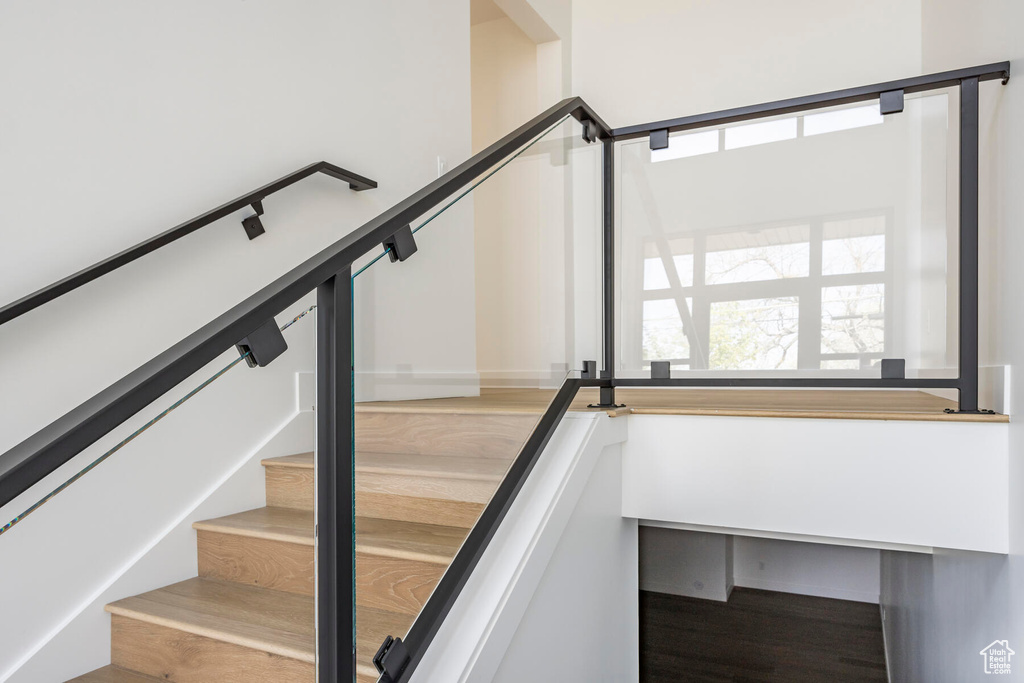 Staircase with hardwood / wood-style flooring