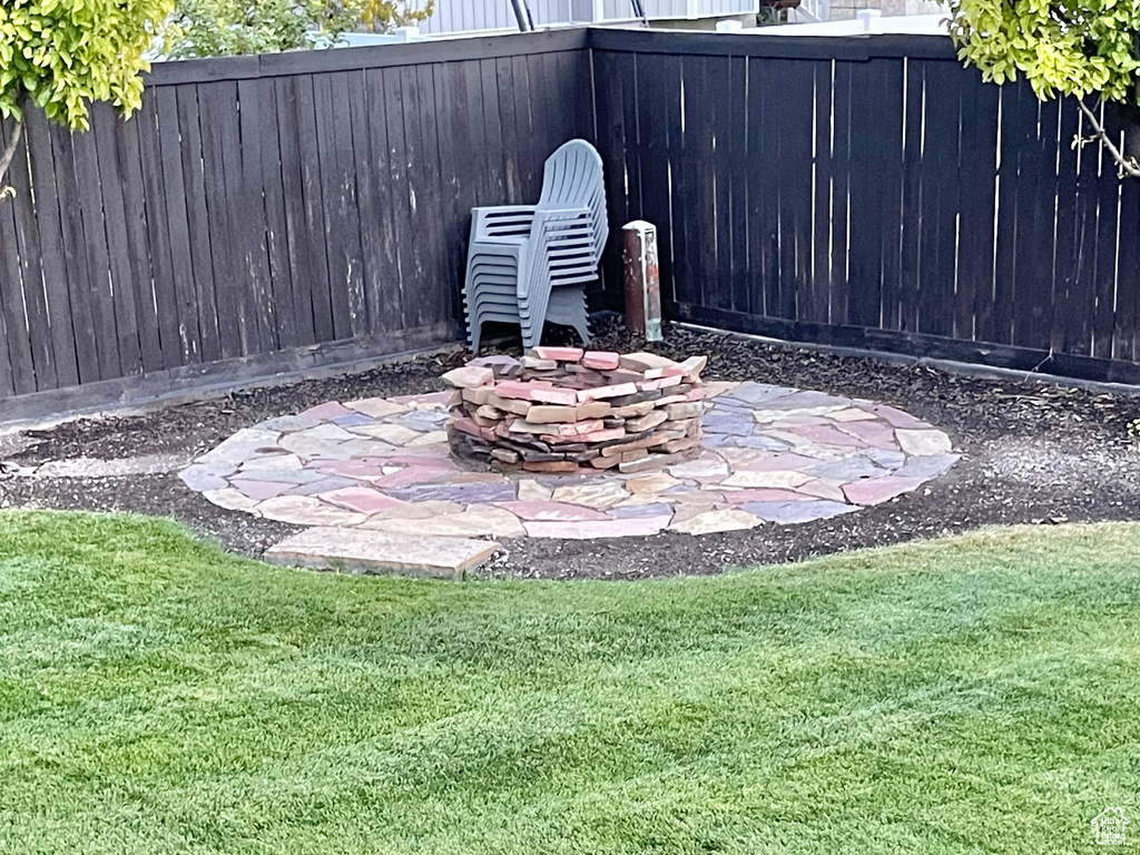 View of yard featuring a patio and an outdoor fire pit