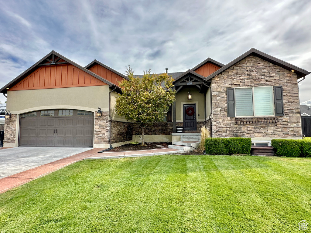 Craftsman-style home with a garage and a front yard