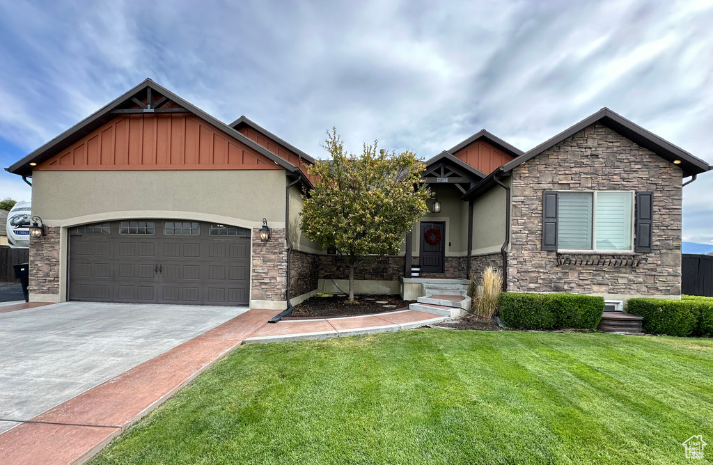 Craftsman-style home with a garage and a front yard