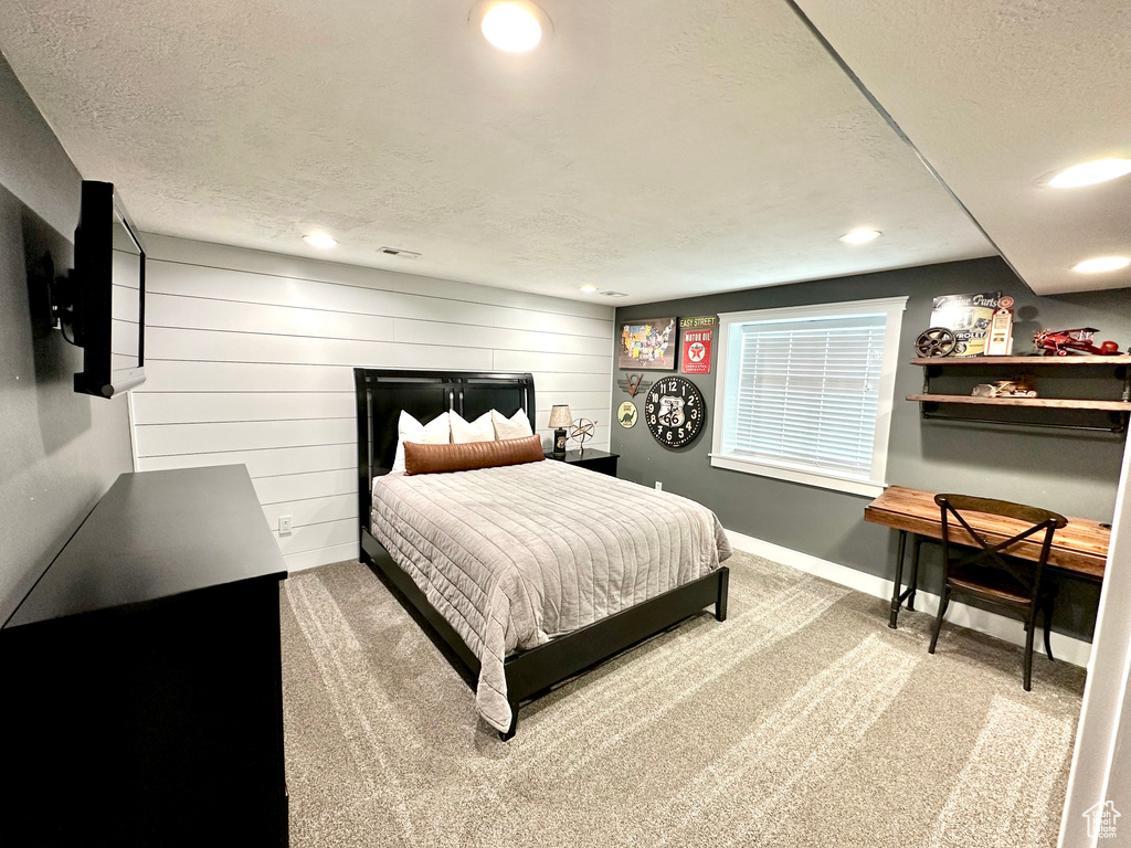 Carpeted bedroom with a textured ceiling