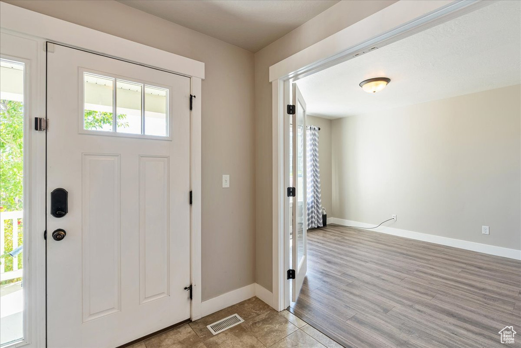 Entryway with light hardwood / wood-style floors