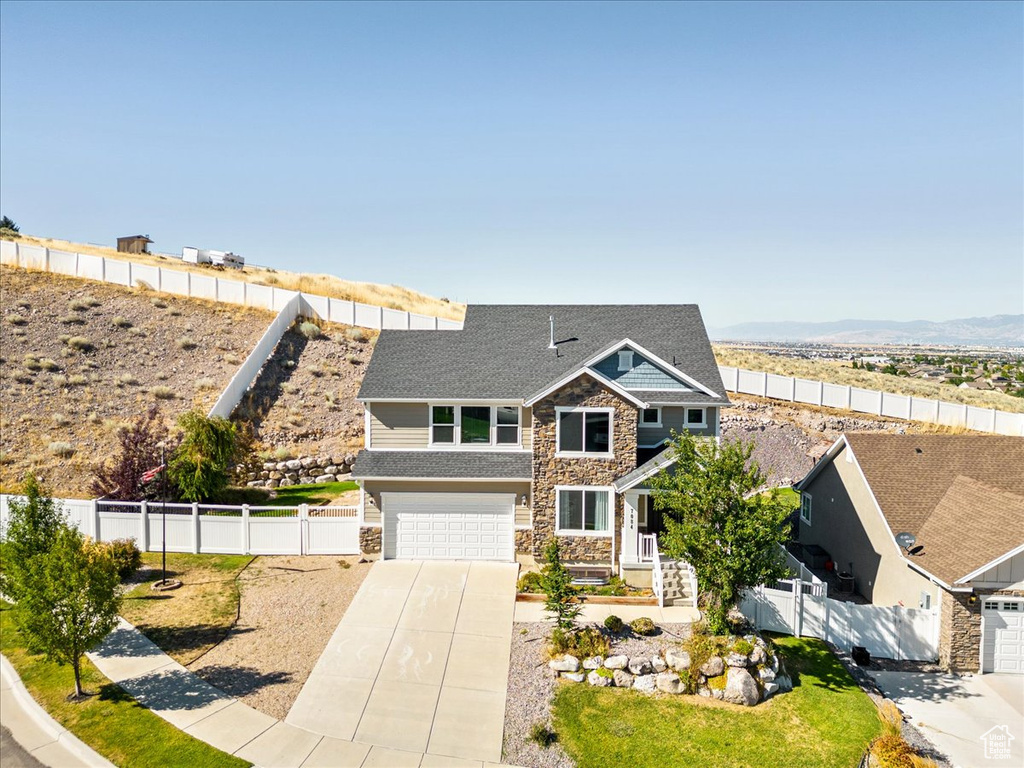 View of front of home featuring a mountain view and a garage