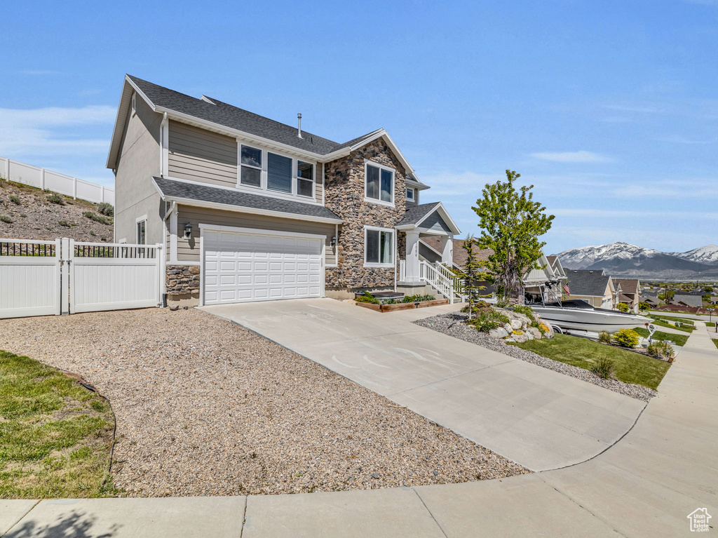 View of front facade featuring a mountain view and a garage