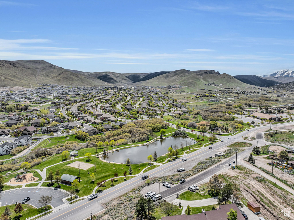 Birds eye view of property with a water and mountain view