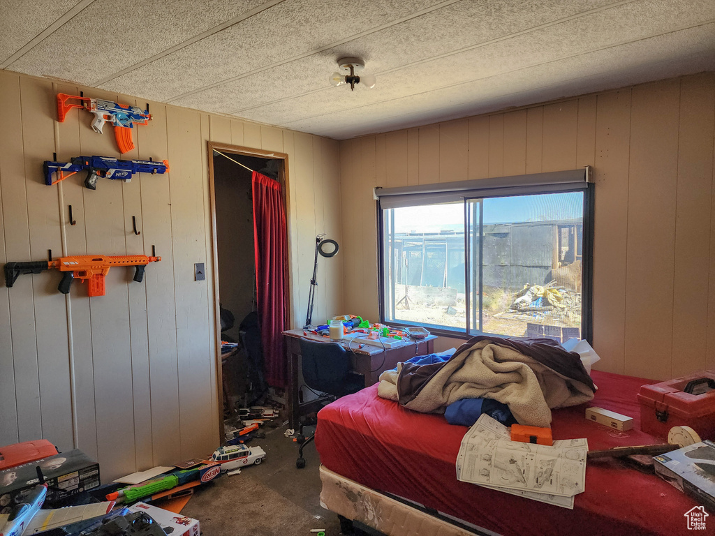 Bedroom with wood walls