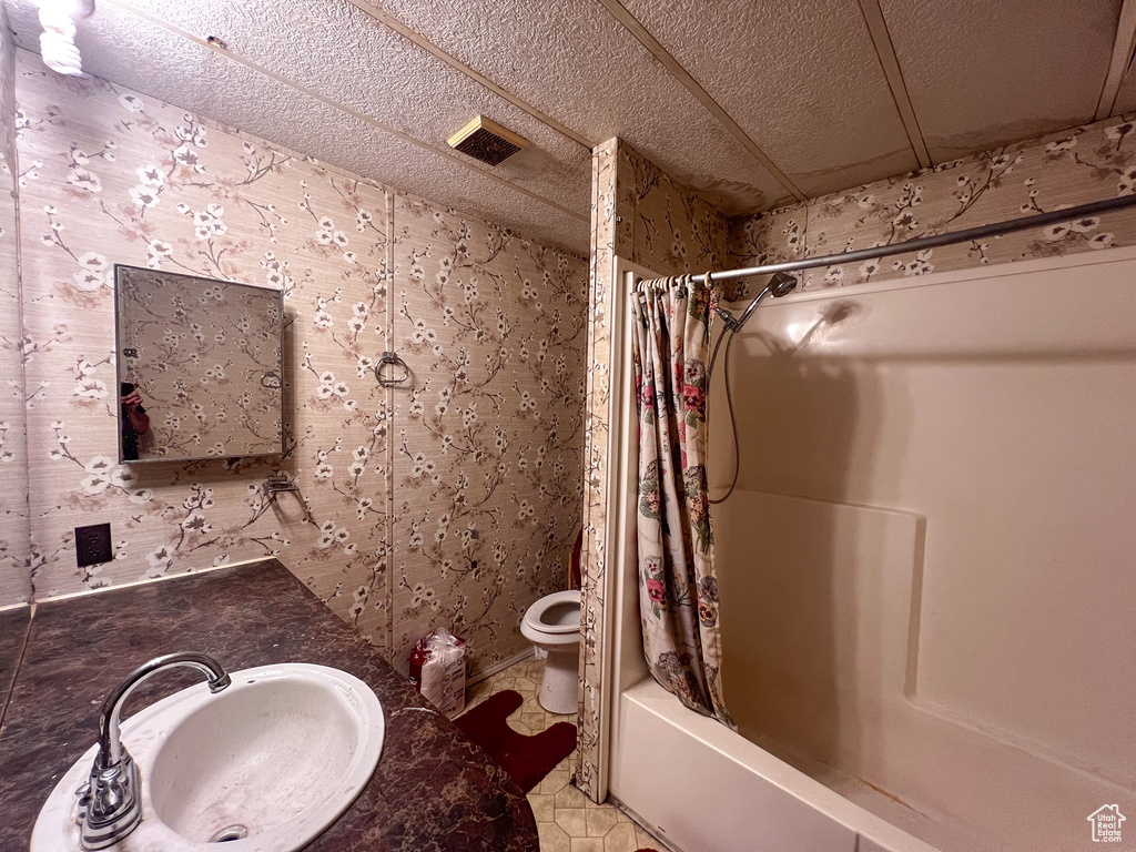 Full bathroom with vanity, toilet, and shower / bath combination with curtain