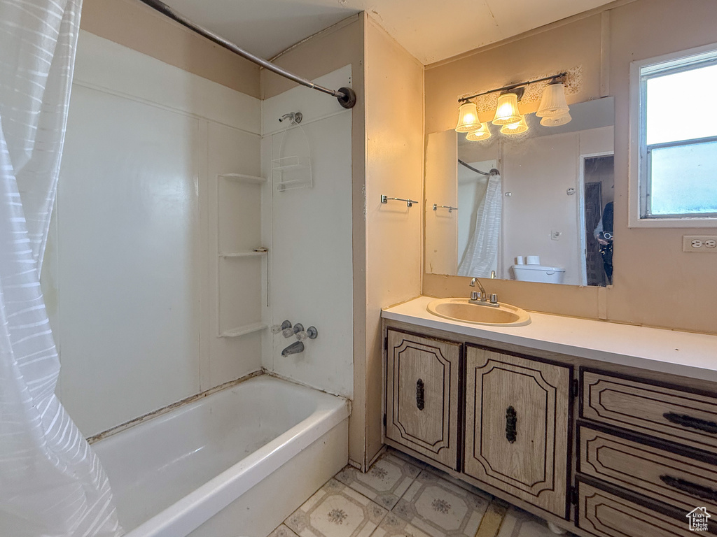 Full bath featuring shower / bathtub combination with curtain and vanity