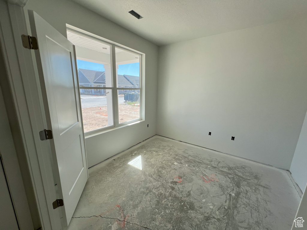 Empty room featuring a textured ceiling