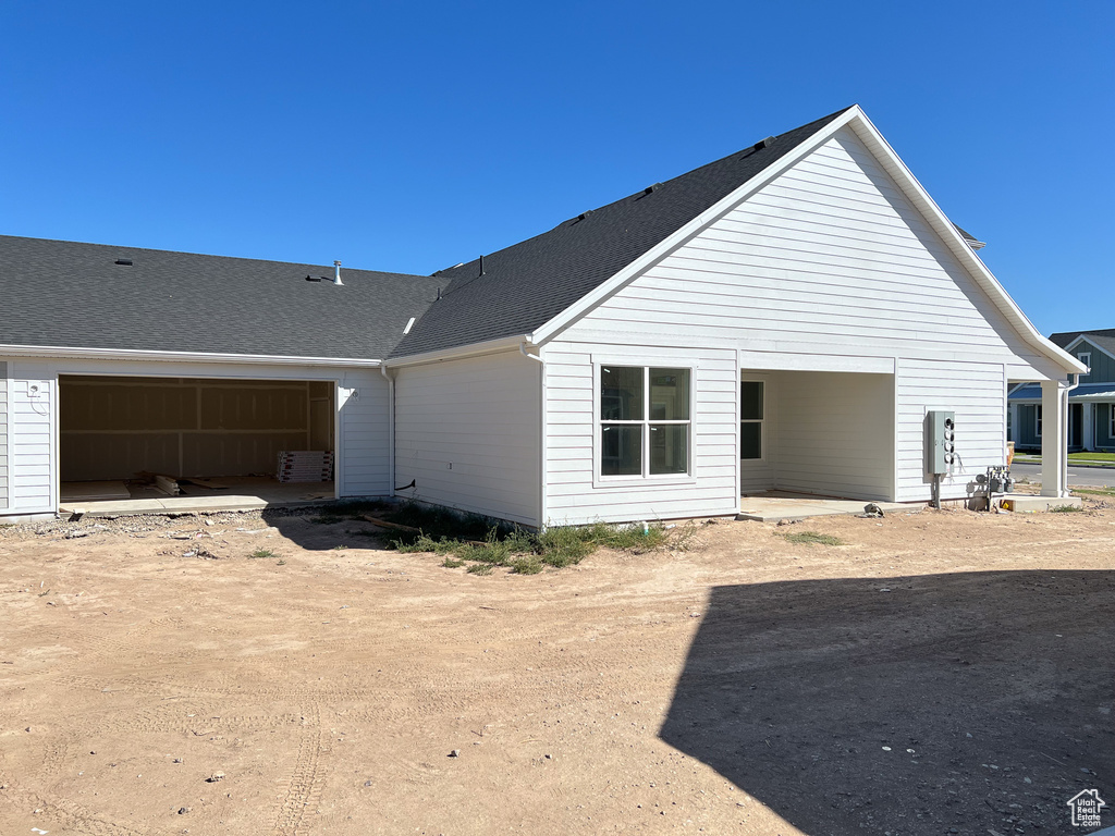 View of side of property with a garage