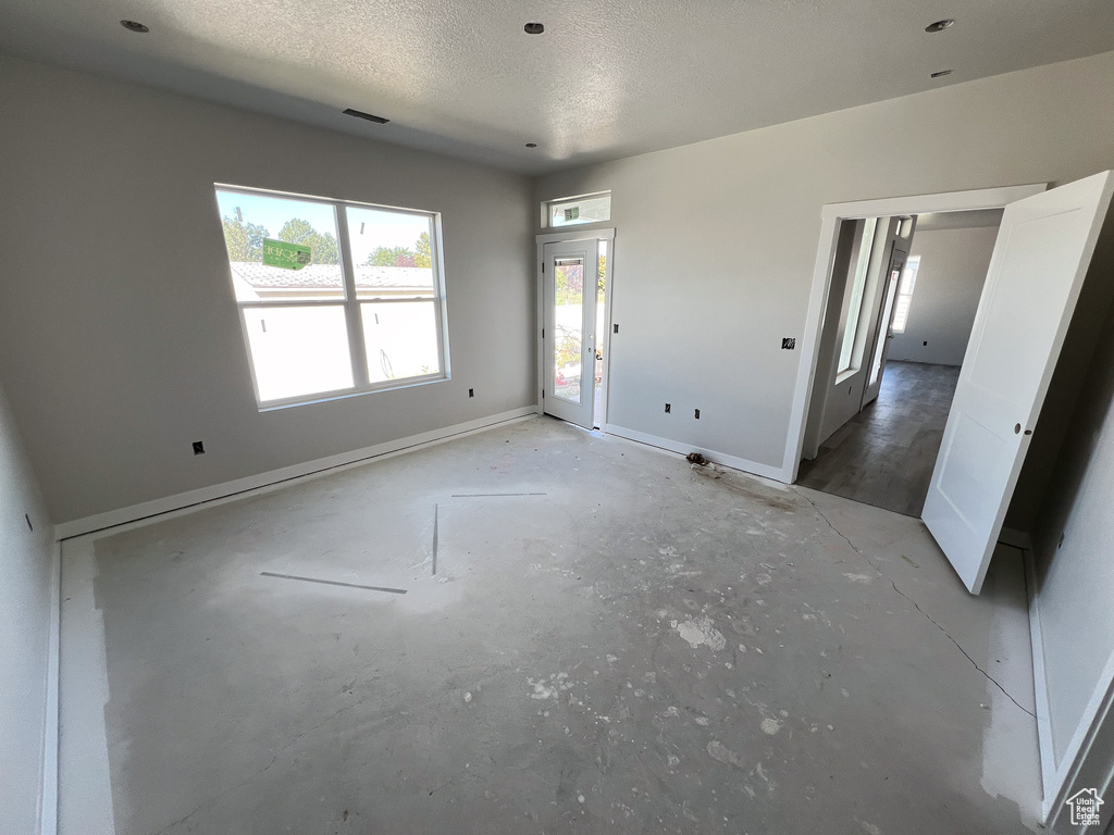 Empty room featuring a textured ceiling