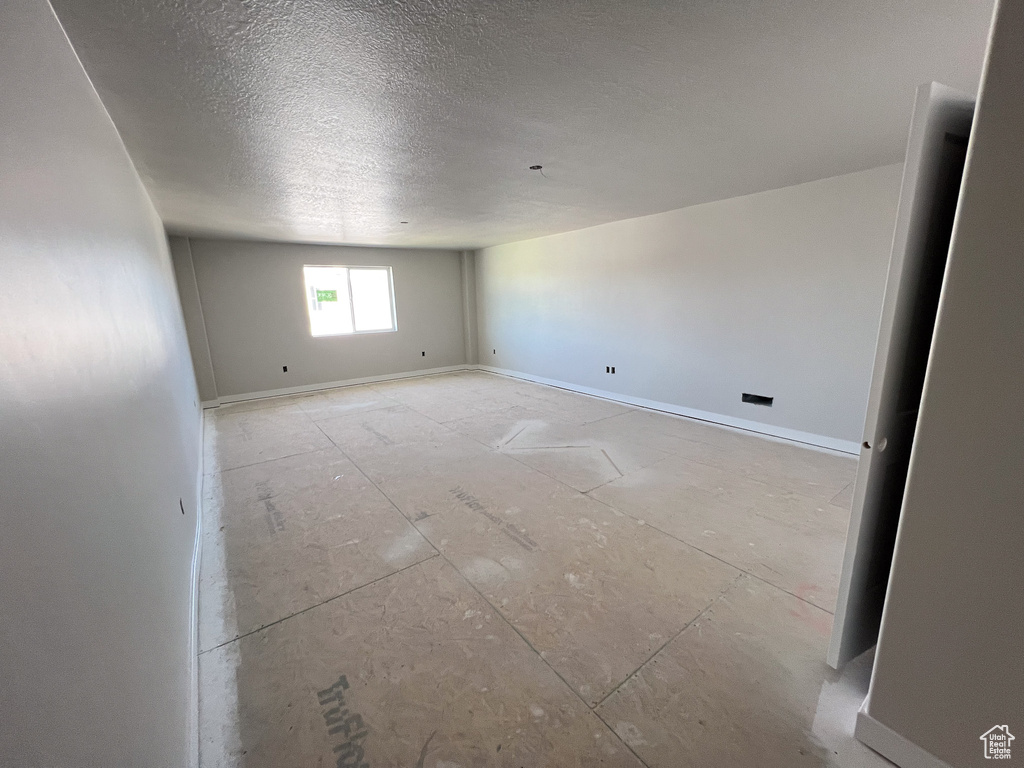 Empty room featuring a textured ceiling