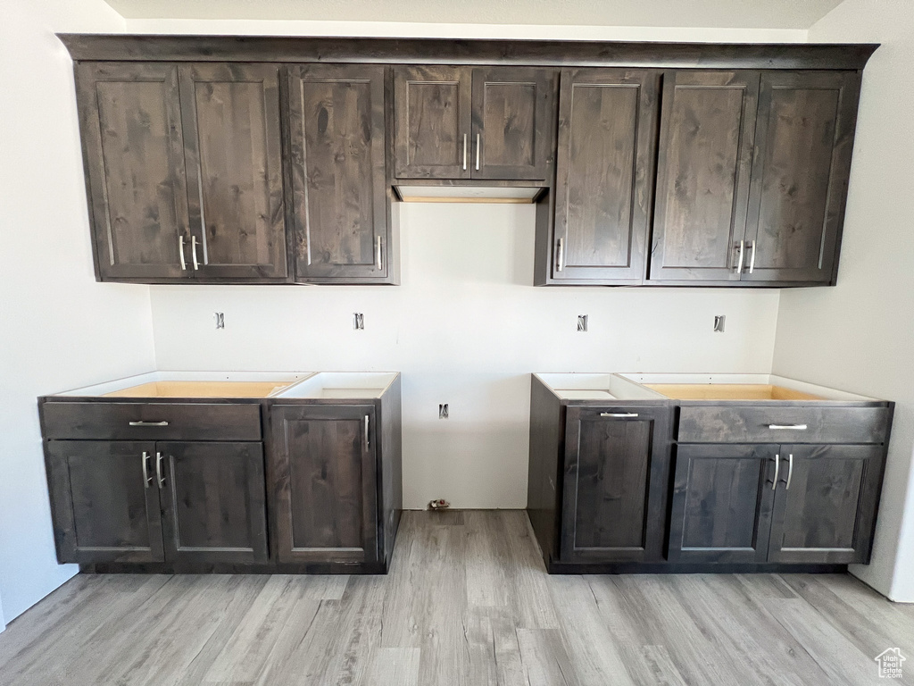 Kitchen featuring light wood-type flooring and dark brown cabinetry