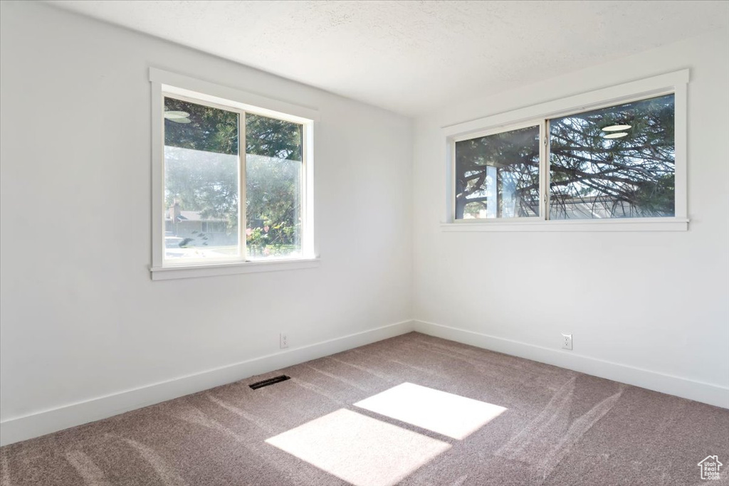 Empty room with carpet floors