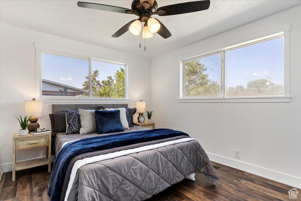 Bedroom with ceiling fan and dark hardwood / wood-style floors