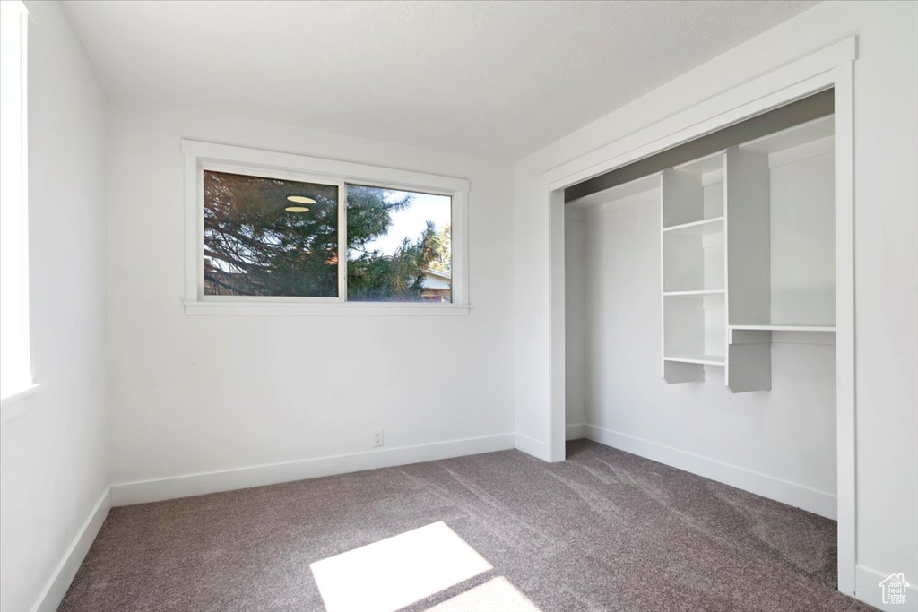 Unfurnished bedroom with carpet and a closet