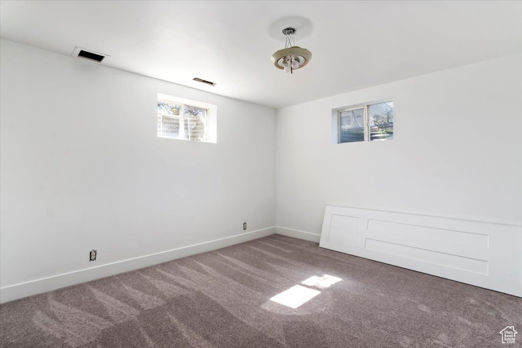 Empty room with plenty of natural light and carpet flooring