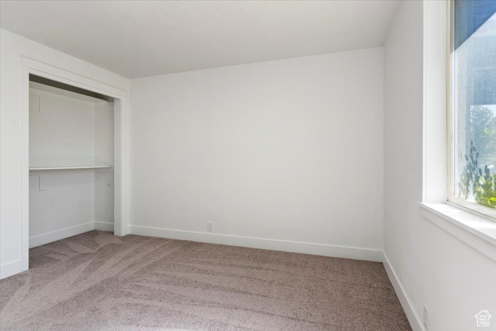 Unfurnished bedroom with carpet and a closet