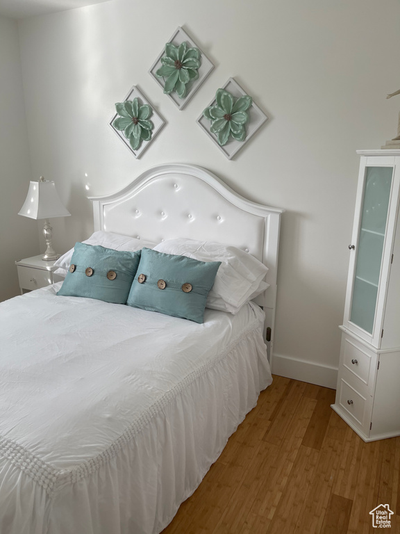 Bedroom with light hardwood / wood-style flooring