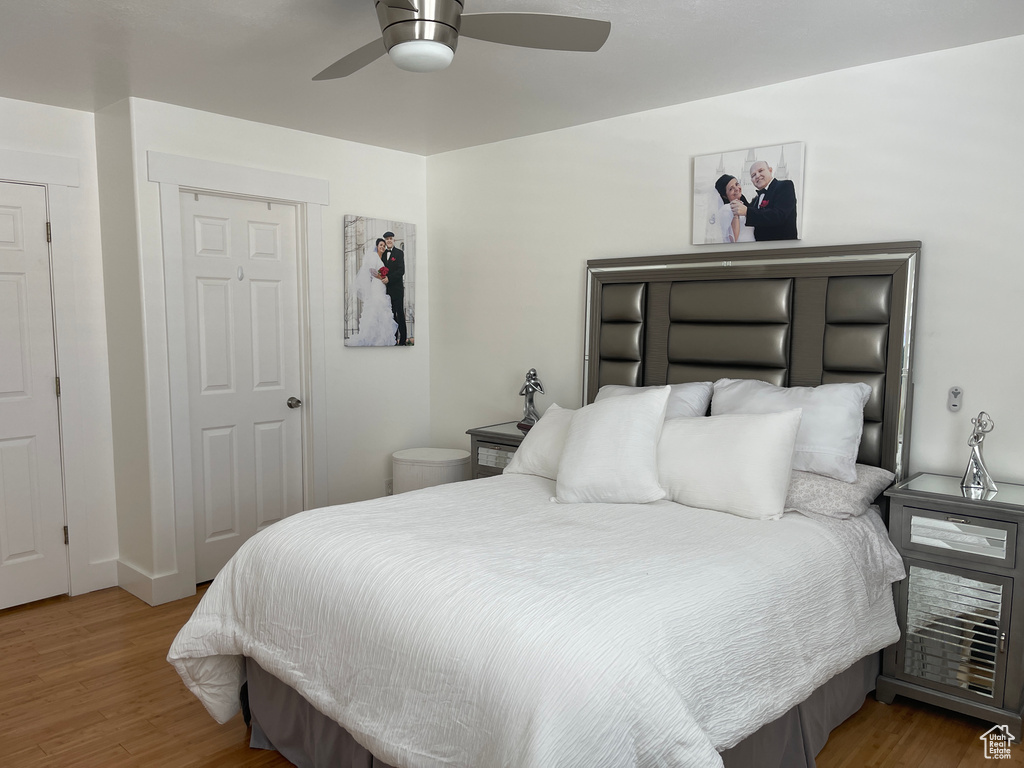 Bedroom featuring ceiling fan and hardwood / wood-style flooring