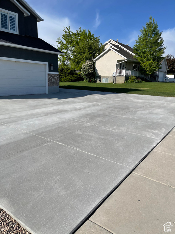 Exterior space featuring a yard and a garage