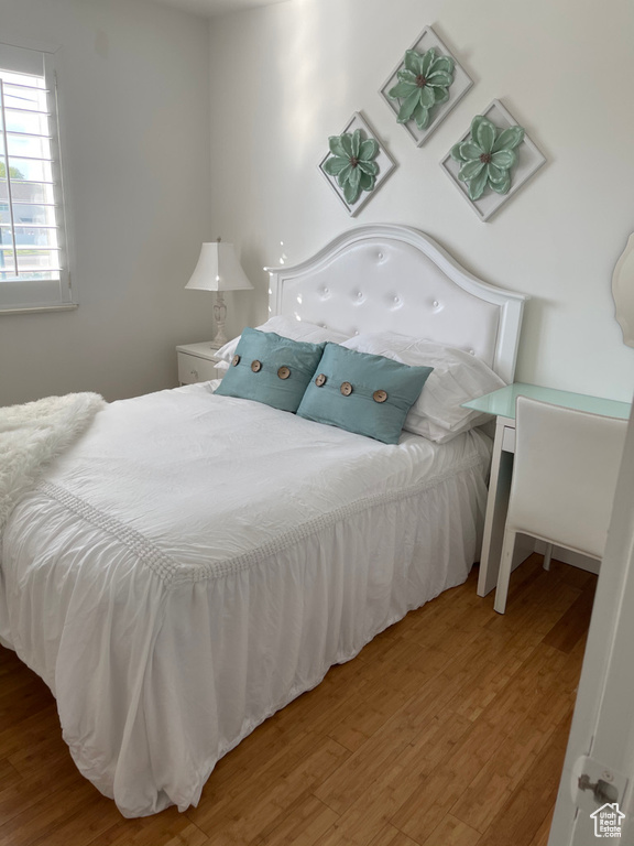 Bedroom with hardwood / wood-style flooring