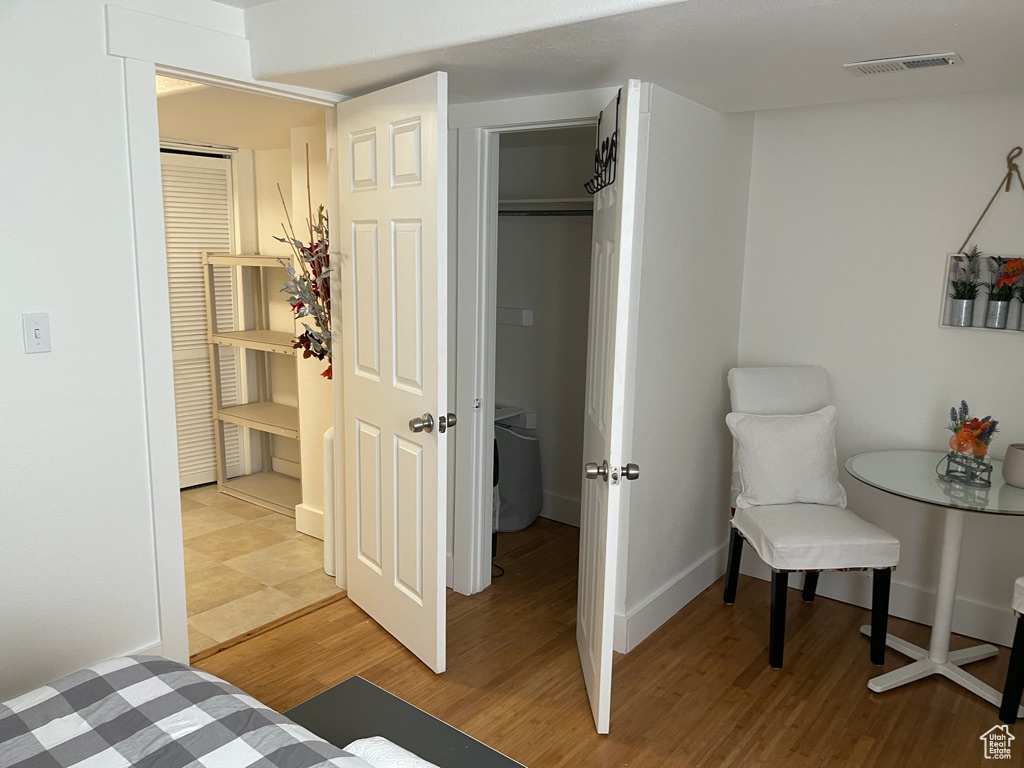 Bedroom with light wood-type flooring and a closet