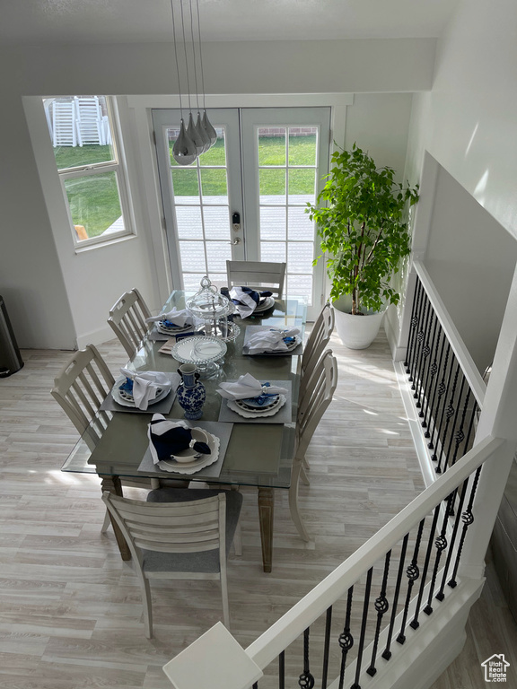 Dining room featuring light wood-type flooring and french doors