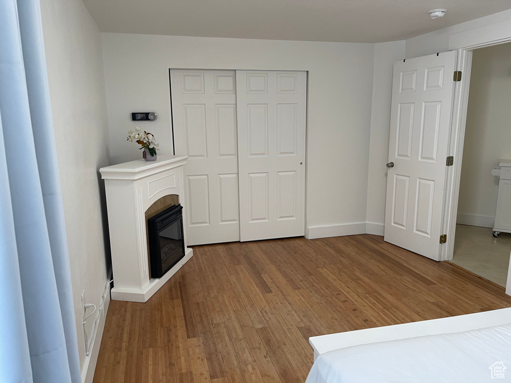 Unfurnished bedroom featuring hardwood / wood-style floors and a closet