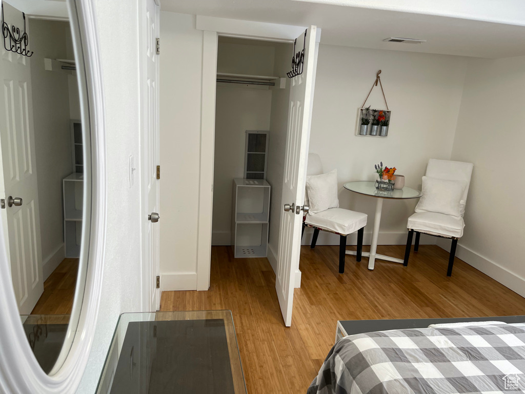 Bedroom with light wood-type flooring and a closet