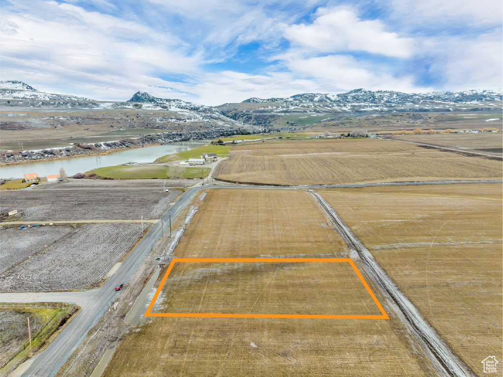 Birds eye view of property with a water and mountain view and a rural view