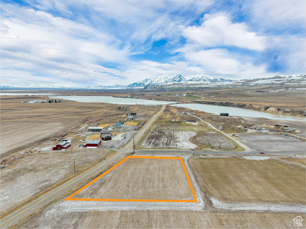 Birds eye view of property featuring a water and mountain view