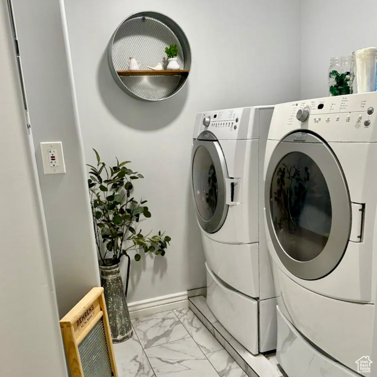 Washroom featuring heating unit and independent washer and dryer